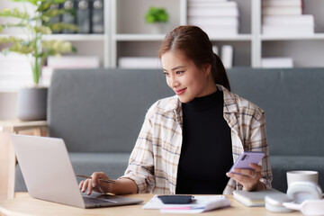 Asian accounting professional calculating household bills, reviewing and analyzing household bills, and filing tax returns.