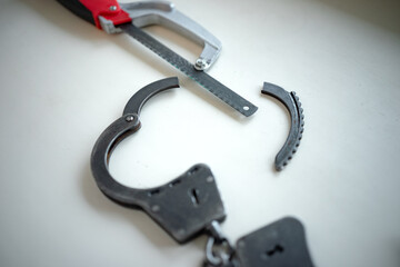 Saw through the police handcuffs.Escape of the criminal.Avoid arrest.Sawn metal handcuffs and a...