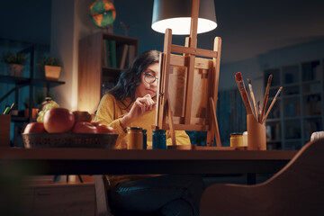 Young artist painting at home