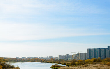 Panorama with river and nature and residential high-rise buildings in the distance