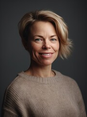Fototapeta premium Portrait of a beautiful middle-aged woman with short blond hair