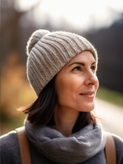 Portrait of a beautiful woman in a knitted hat and scarf