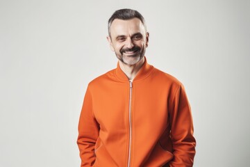 Obraz premium Portrait of a smiling middle-aged man in an orange hoodie.