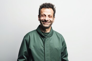 Fototapeta premium Portrait of a smiling man in a green hoodie on a white background