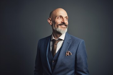 Portrait of a smiling senior businessman in suit. Studio shot.