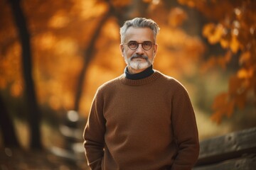 Portrait of a senior man in the autumn park. Selective focus.