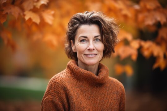Pet portrait photography of a grinning woman in her 40s wearing a cozy sweater against an autumn foliage background. Generative AI
