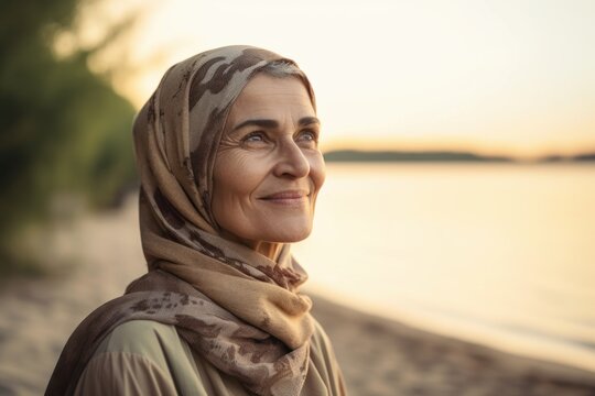 Portrait of beautiful middle-aged woman wearing headscarf on the beach