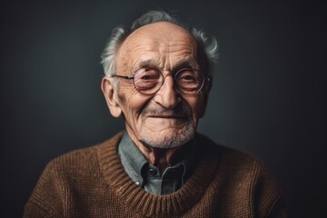 Portrait of an old man with glasses on a dark background.