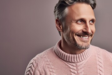 Portrait of a handsome middle-aged man in a pink sweater.