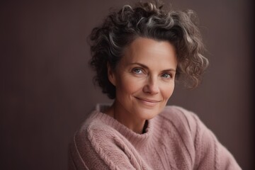 Portrait of a middle-aged woman in a pink sweater.