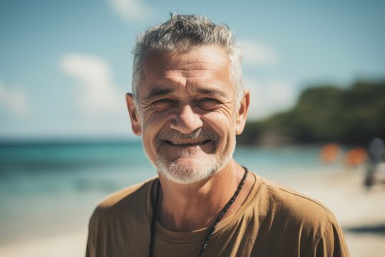 Environmental portrait photography of a cheerful man in his 60s wearing a casual t-shirt against an island or beach paradise background. Generative AI