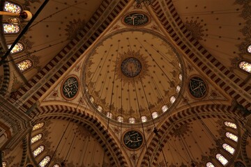 Naklejka premium Istanbul, Turkey. 04.29.2023 View from inside the dome of Fatih Mosque (Conqueror's Mosque). Public Ottoman mosque in the Fatih district of Istanbul, Turkey, with a huge decorated domes