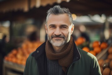 Portrait of a senior man at the market in autumn, looking at camera