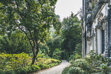 public park with cobblestone pathway. Old building and trees around