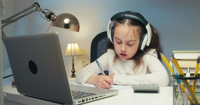 Girl Child Studying in Online Kolas at Home. Back to School, Online Learning, Distance Lesson, Homeschooling, School Technology, Tutored Lessons. Children Doing Homework at Home