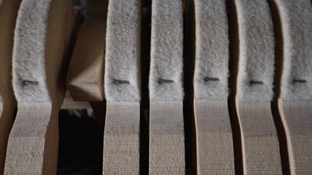 Inside the piano. Close-up view of hammers and strings inside the upright piano.