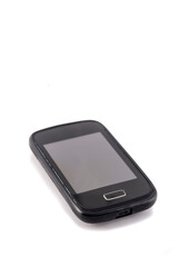 Old black mobile phone isolated on white background. Focus on the screen.
