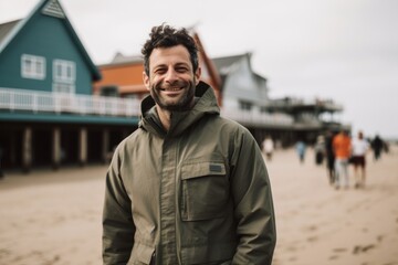 Portrait of a smiling man standing on the beach at the seaside