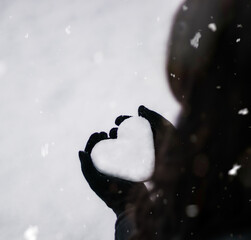 Snow heart with snowflakes in winter