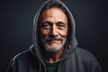 Naklejka na ściany i meble Environmental portrait photography of a satisfied man in his 50s wearing a stylish hoodie against a chalkboard or blackboard background. Generative AI