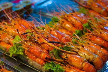Grilled shrimp that's being cooked with smoke on the grill.
