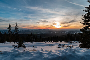Winter landscape with sunset on the mountain