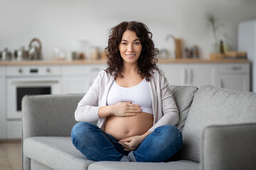 Beautiful Pregnant Woman. Portrait Of Smiling Young Expectant Female Posing At Home