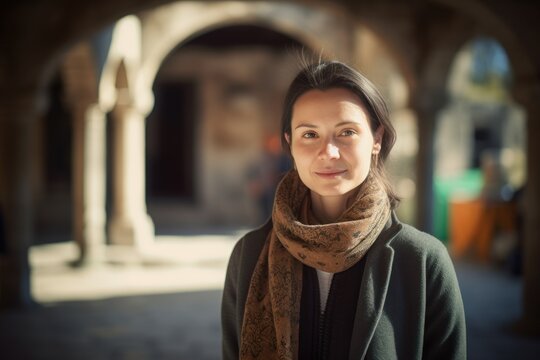 Group portrait photography of a pleased woman in her 30s wearing a chic cardigan against a monastery or spiritual retreat background. Generative AI