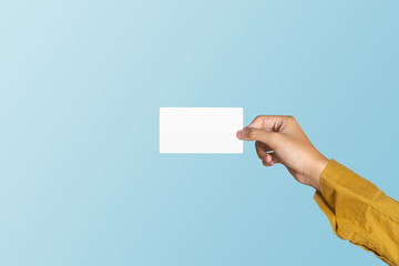 Hand holding blank white card on blue background include cutting path concept of business and finance