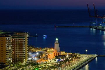 Fototapeta na wymiar MALAGA, SPAIN - March 08, 2023. Lighthouse Farola in Malaga port
