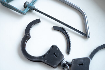 Cut the handcuffs with a hacksaw on metal.Get rid of the closed metal handcuffs with a saw. Escape...