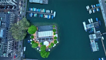 Top view of City of Zürich on a cloudy spring evening with Limmat River and quayside with moored boats. Movie shot May 6th, 2023, Zurich, Switzerland.