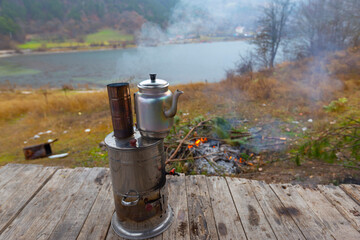 Turkish samovar outdoor. Preparing tea outside on the nature on double pot on the fire.