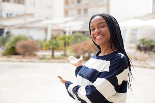 Afro Pretty Black Woman Feeling Happy And Cheerful, Smiling And Welcoming You, Inviting You In With A Friendly Gesture