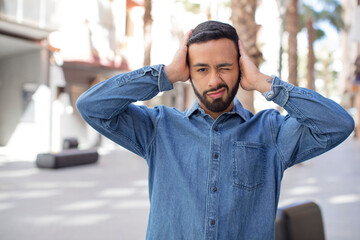 Fototapeta premium young handsome man feeling frustrated and annoyed, sick and tired of failure, fed-up with dull, boring tasks