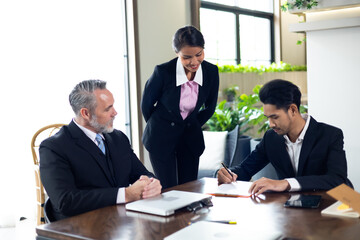 Fototapeta premium Business contract and agreement concept. Senior business man and young business asian man signing contract for investment or buy estate and insurance