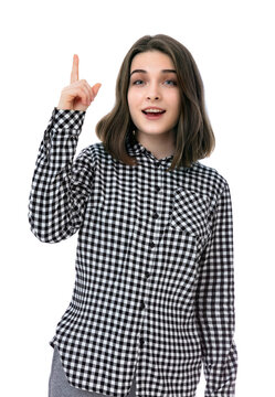 Portrait of brunette eighteen year old girl raising fore finger up while smiling confident and happy, isolated on white background. Young caucasian woman smiling on camera and posing in studio.
