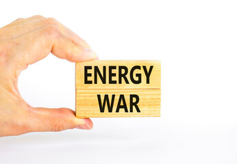 Energy war symbol. Concept words Energy war on beautiful wooden block. Beautiful white table white background. Businessman hand. Business and Energy war concept. Copy space.