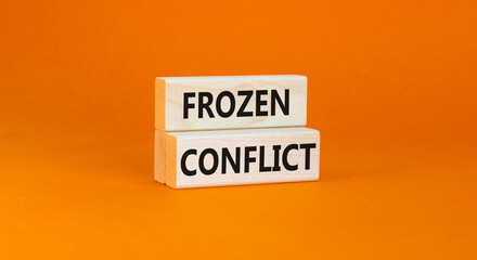 Frozen conflict symbol. Concept words Frozen conflict on beautiful wooden block. Beautiful orange table orange background. Business and Frozen conflict concept. Copy space.
