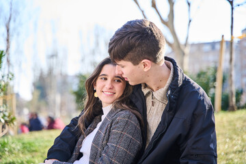 Loving young couple hugging and smiling together on city background