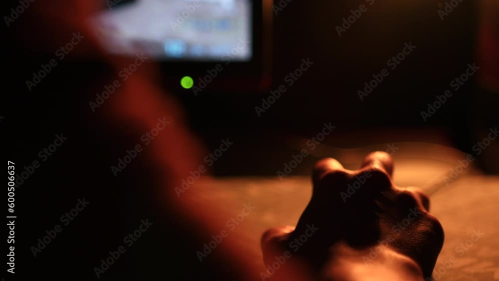 Poster close-up of gamer moving computer mouse. stock footage. gamer plays on computer late at night. hand 