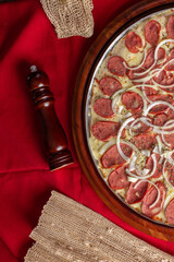 pepperoni pizza on wooden background. Brazilian pizza called pizza de calabresa. top view