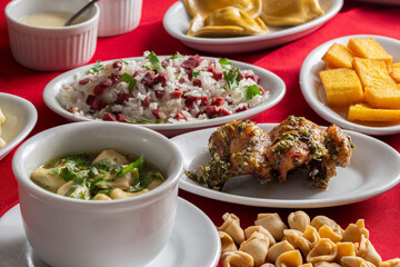 A baby chicken called galeto in Brazil served with herbs, potato salad, wine onion, fried polenta, rice with dried meat and potato salad