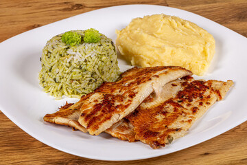 fish fillet, served with mashed potatoes and rice with broccoli