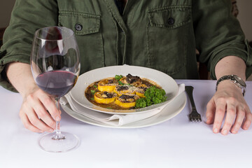 woman eating pasta at restaurant