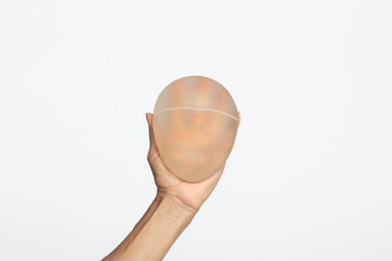  hands hold breast silicone breast implant