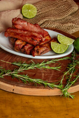 Roasted pork ribs served with lemon wedges