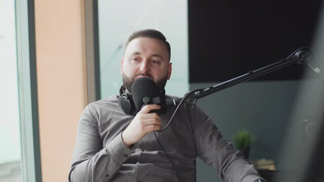 Portrait of happy young man working as radio host at radio station.
