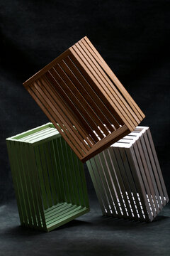 Multicolored boxes made of wooden slats on a dark background